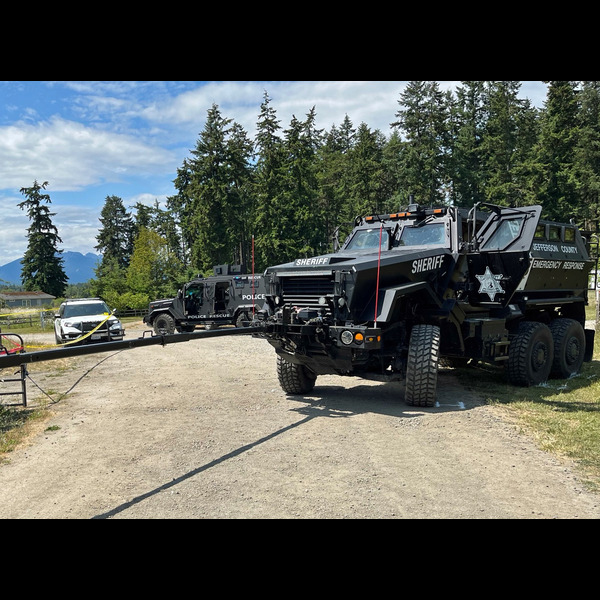 A small logo depicting the news story BARRICADED SEQUIM MAN ARRESTED AFTER FIRING SHOTS AT LAW ENFORCEMENT
